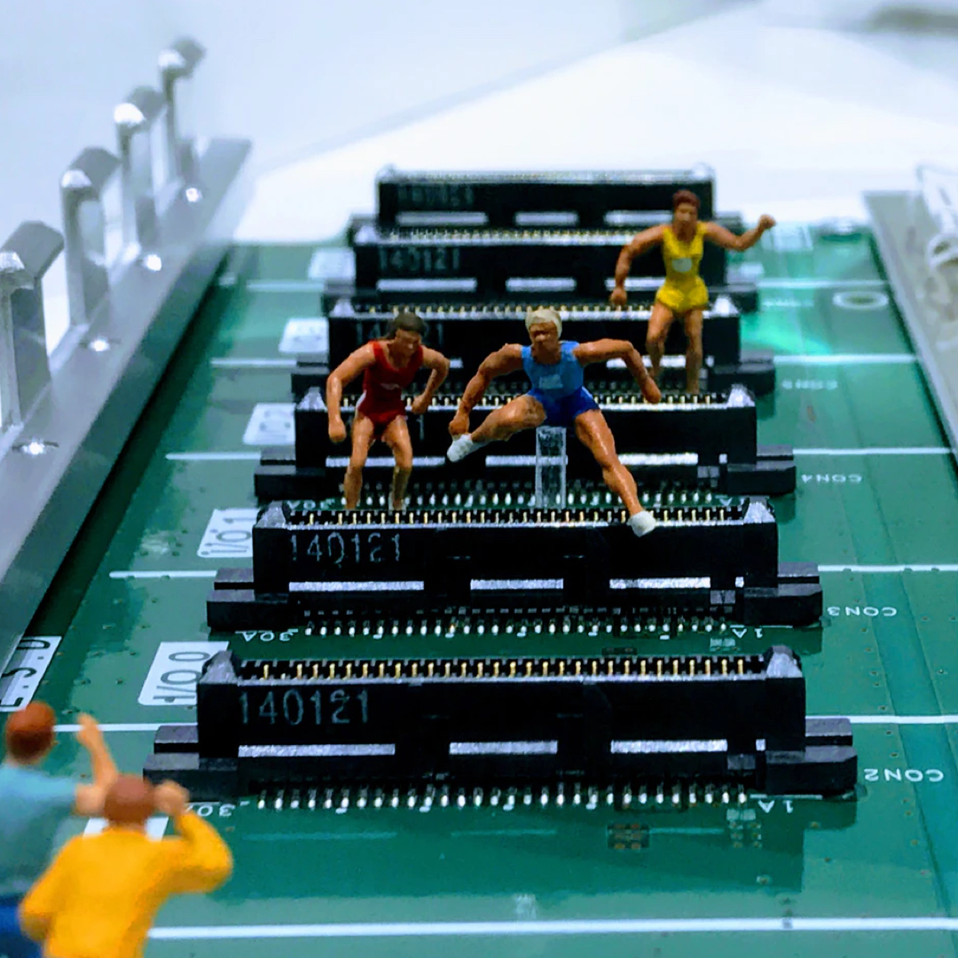 Minuscule models of hurdlers jumping over computer internals